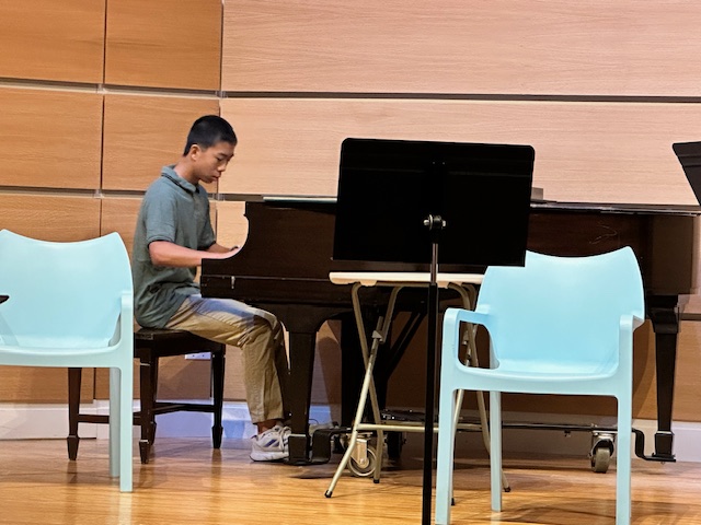 Matthew Ding performing at the concert he organized.