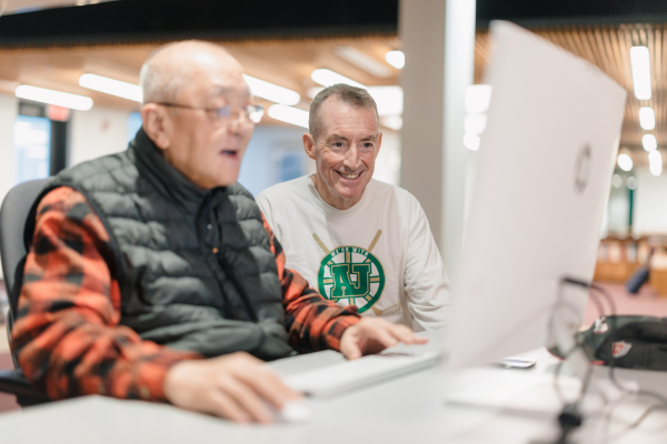 2Life residents using computer in common area