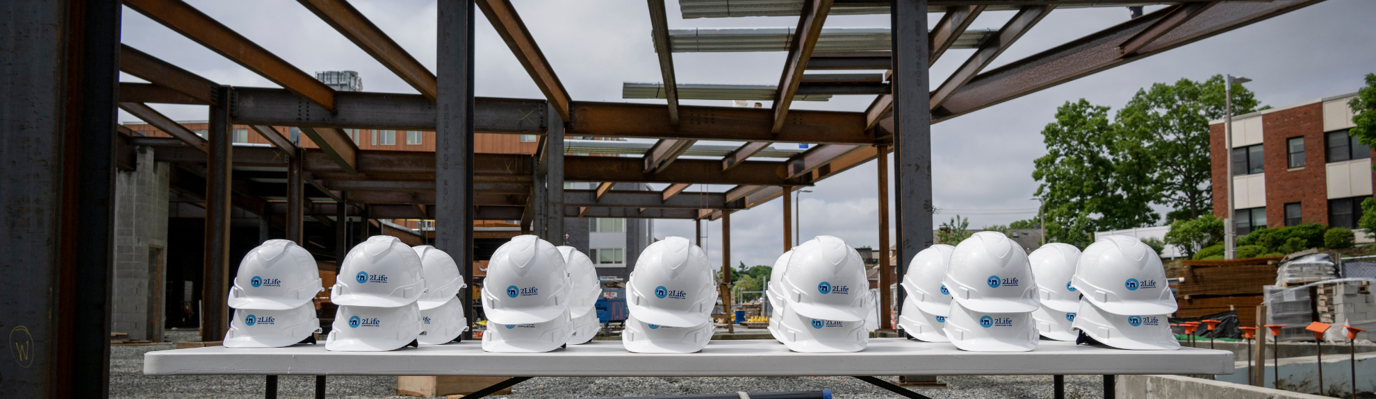 White hardhats outside of a building development site