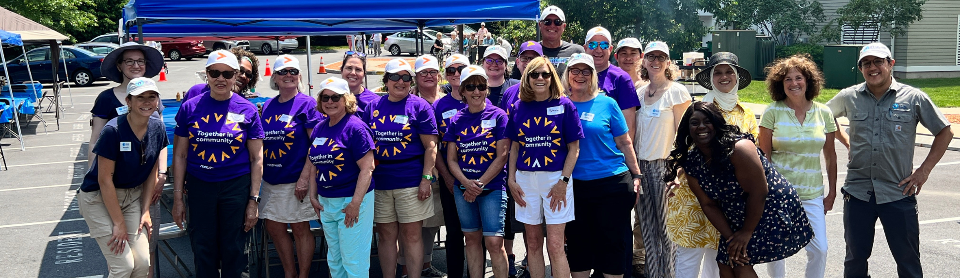 Volunteers and 2Life staff members outdoors at an event