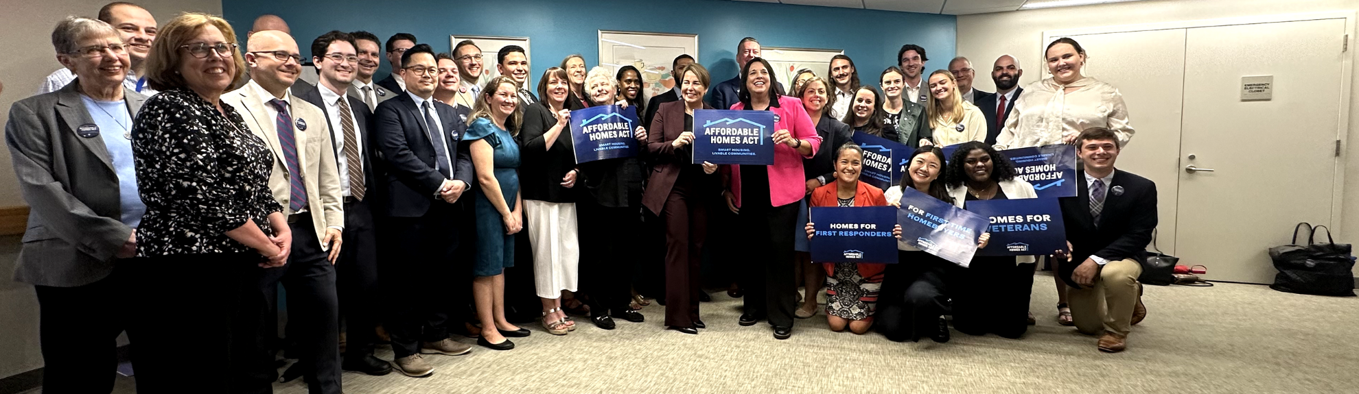 2Life staff and policy makers gather to sign the Affordable Homes Act at Golda Meir House in Newton, MA
