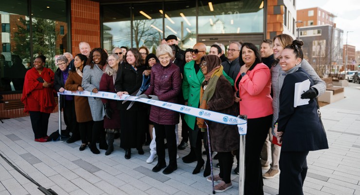 State and local officials meet to cut the ribbon at J.J. Carroll House