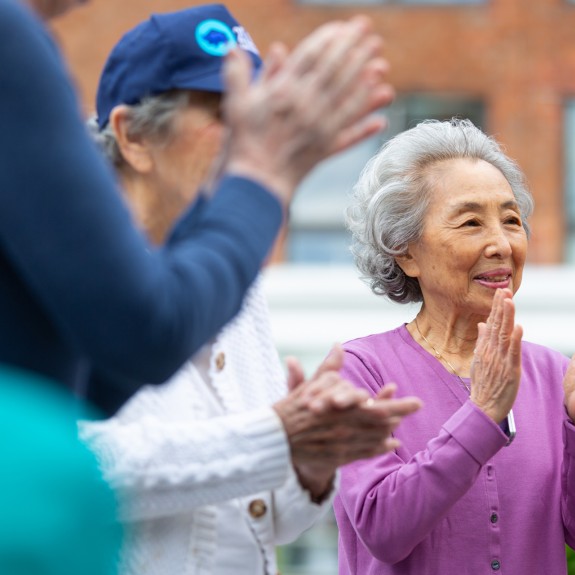 A woman clapping in a crowd