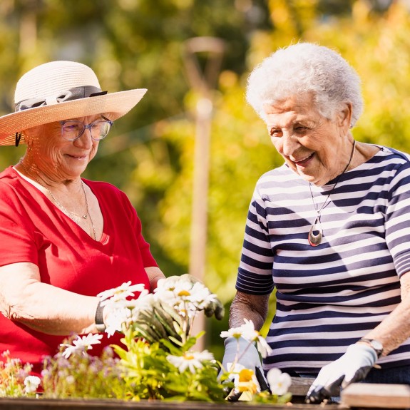 Two people happily gardening