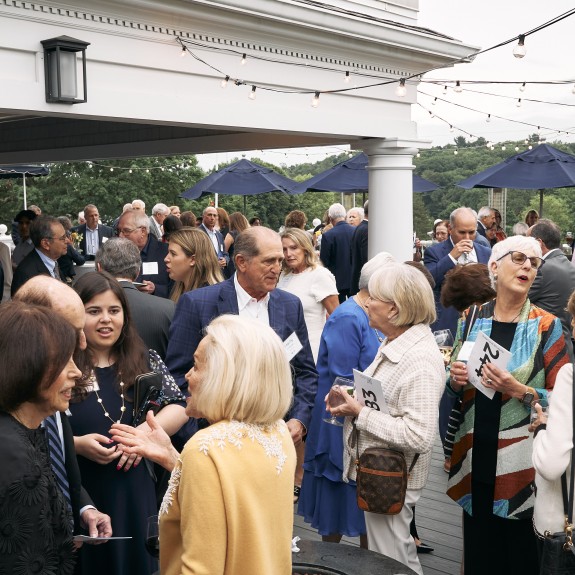 A group of 2Life staff, residents, and donors outside at an event 