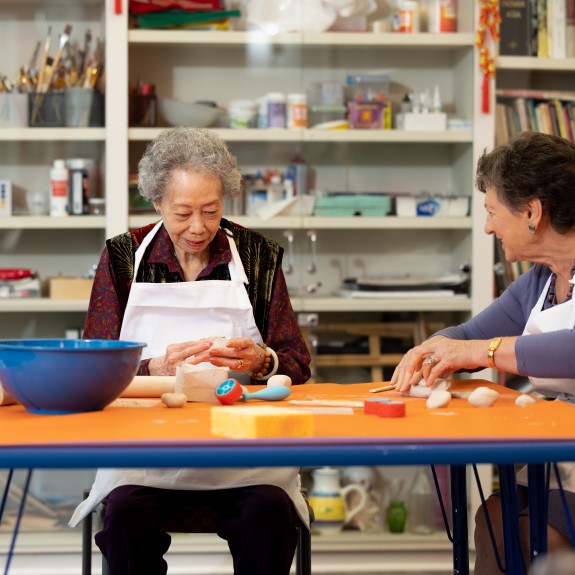 three residents in a 2Life community art room