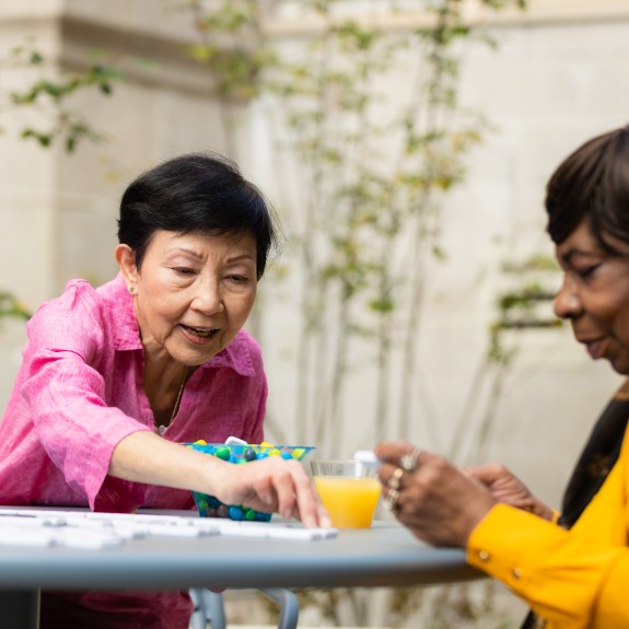 Residents connecting in a 2Life Communities courtyard