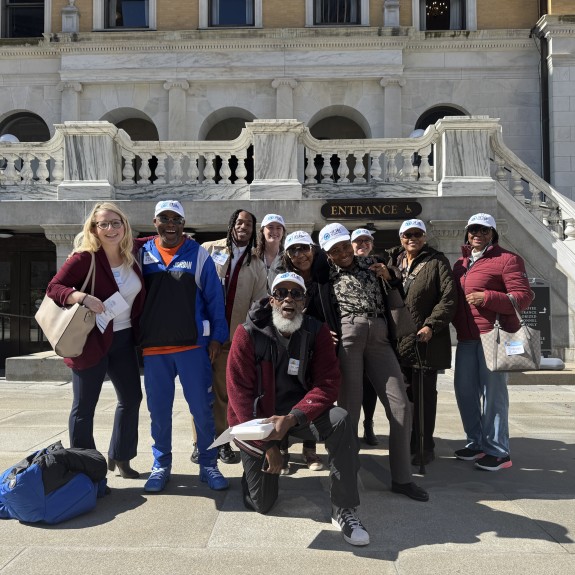 2Life staff and residents posing outside of the state house in Boston, MA