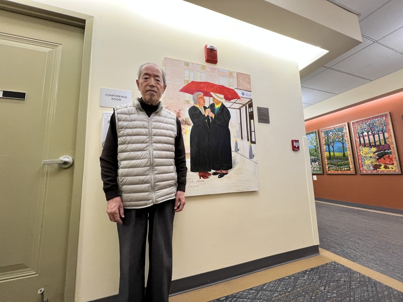 Yon Xin Zhao next to art inside a 2Life campus building