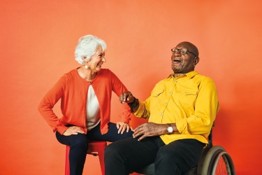 two people sitting together laughing