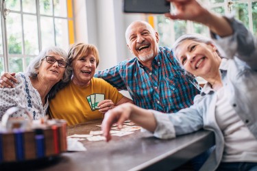 Four people posing for a selfie around a table