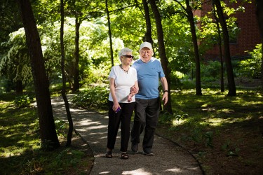 Two people walking through a wooded area