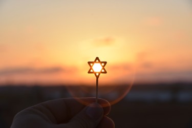 Star of David against a sunset backdrop